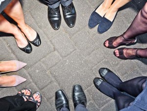 shoes of party people standing in a circle